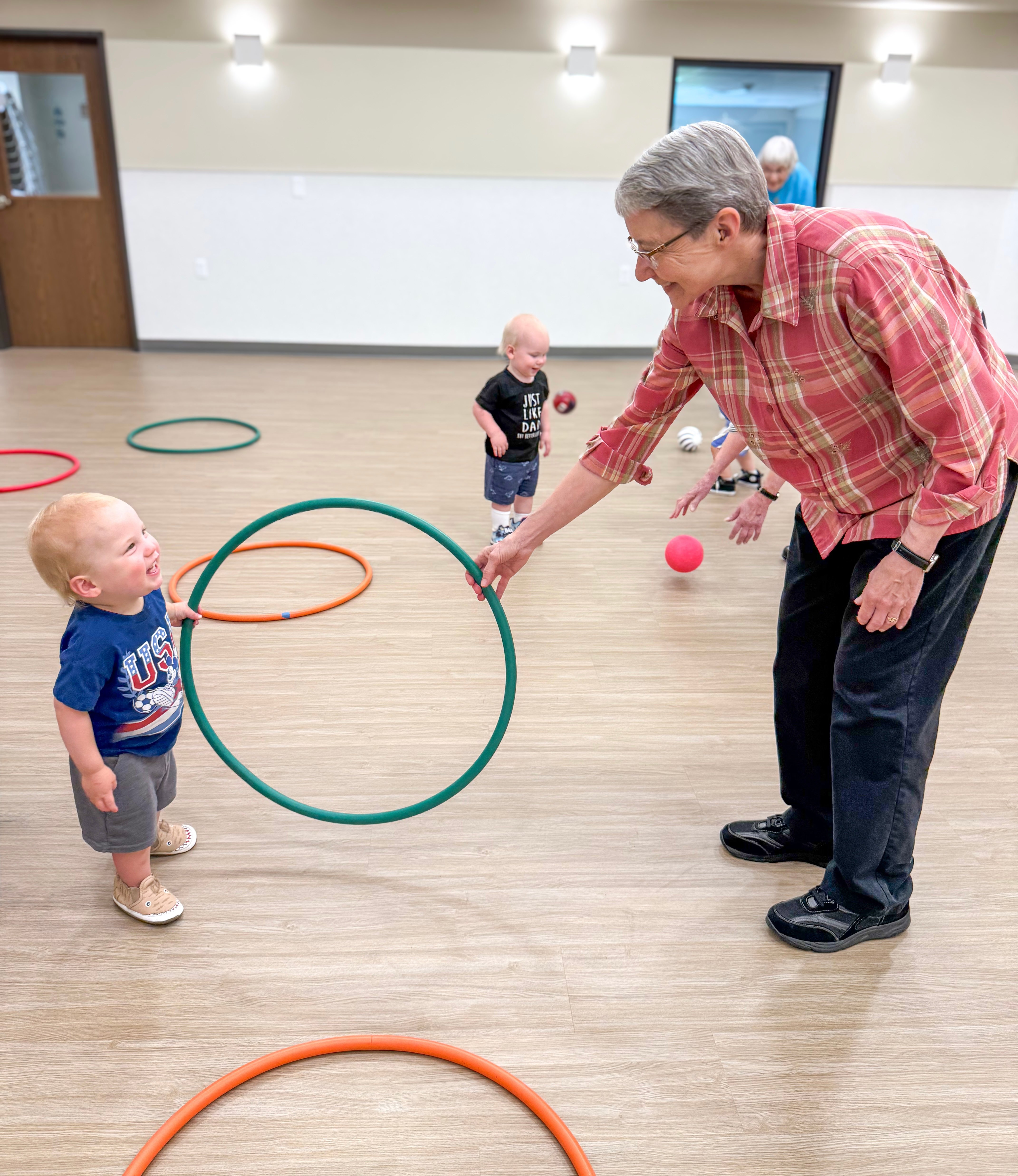 Sister Eileen shares a playful moment with a little one at Our Little Village Learning Center.